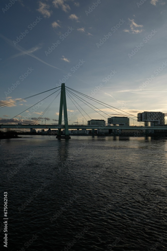 Severin Bridge in Germany, illuminated in the evening against the backdrop of a vibrant cityscape