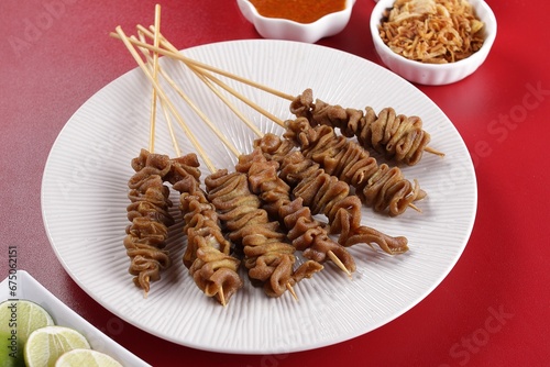 Sate taichan is a variation of chicken satay grilled and served without peanut or ketjap seasoning unlike other satays. It is served with sambal and squeezed key lime, photo