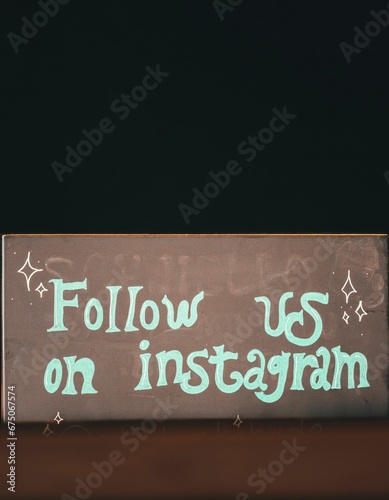 Chalkboard sign with the words 'Follow us on Instagram' written on it