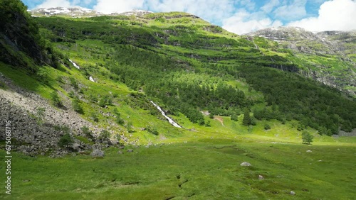 Drone footage over Nyastolfossen Waterfall landscape in Norway with forest trees photo