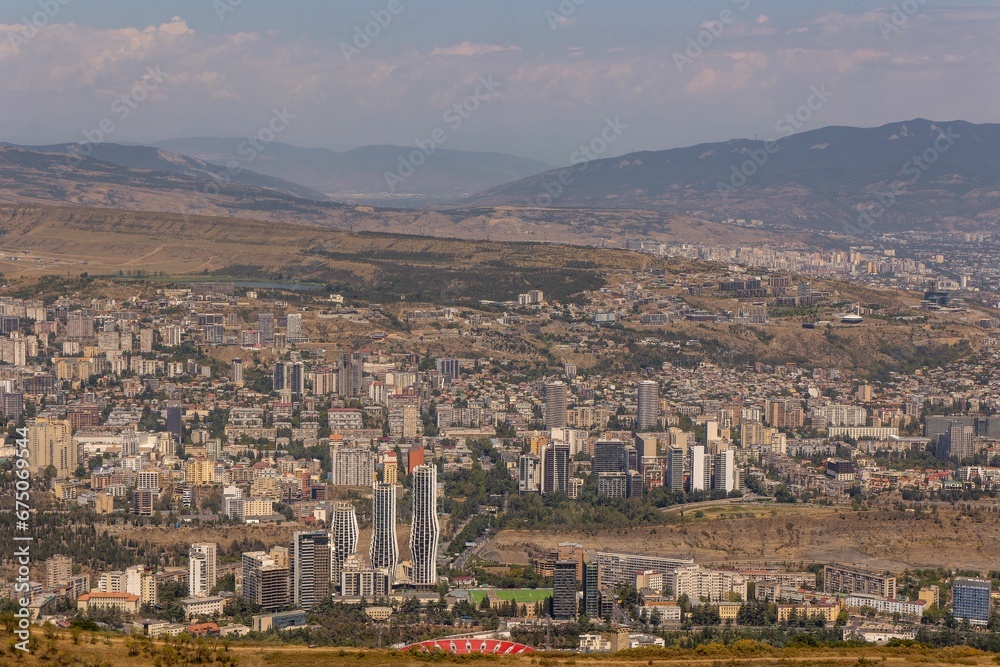 Aerial view of Vere in the Old Tbilisi District, with a cityscape and a vast field in the foreground
