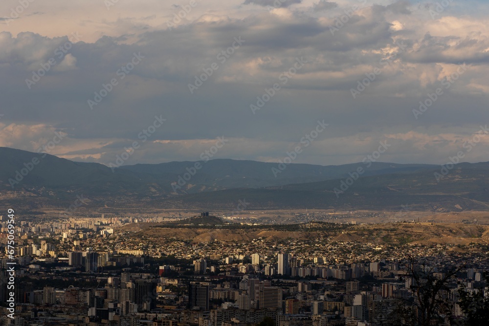 Scenic view of Vake District, Tbilisi, Georgia cityscape, surrounded by lush green plains