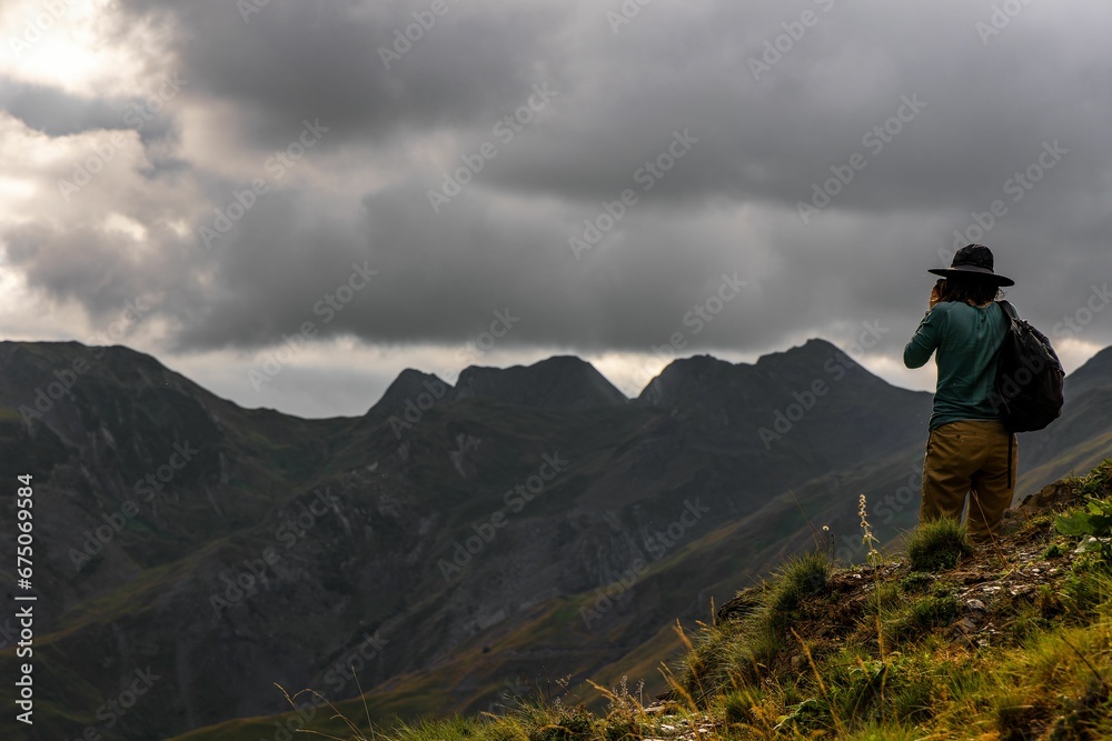 Male standing on top of a hill with a beautiful view of the valley below