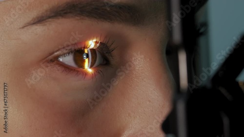 Close up view of The ophthalmologist examines the patient's eye photo