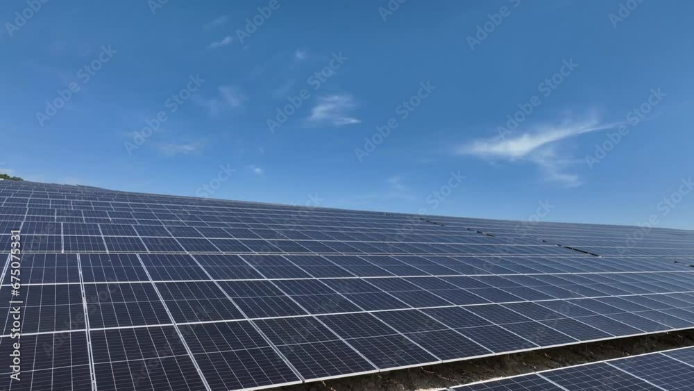 Solar panels making sustainable green energy from sun. Aerial flight over large solar farm. Green free clear energy. Solar panels making sustainable green energy from sun. Aerial flight over large solar farm. Green free clear energy.
