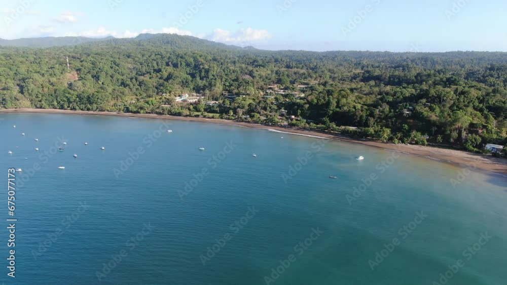 Costa Rica beach drone view showing sea, shore and forest on a sunny day over the pacific ocean in the caribbean Costa Rica beach drone view showing sea, shore and forest on a sunny day over the pacific ocean in the caribbean