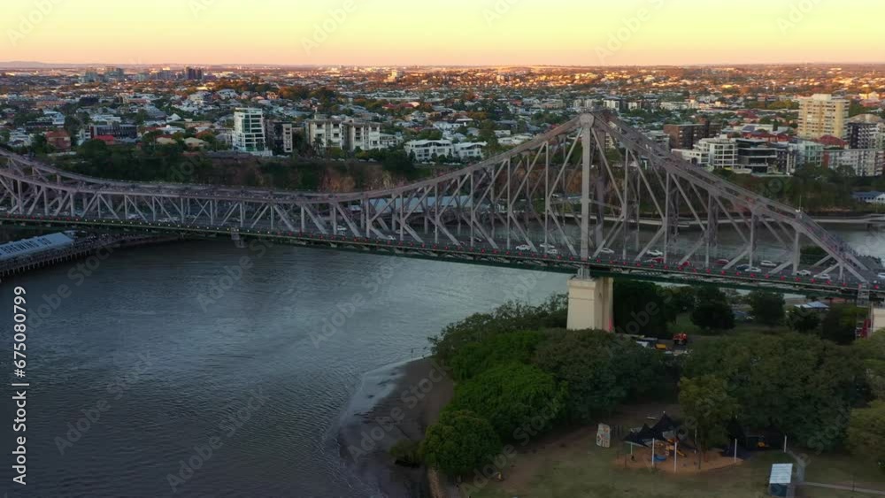 Aerial view of iconic landmark Story bridge against cityscape of New Farm neighborhood at sunset dusk, busy vehicle traffics crossing Brisbane river between Kangaroo point and Fortitude valley. Aerial view of iconic landmark Story bridge against cityscape of New Farm neighborhood at sunset dusk, busy vehicle traffics crossing Brisbane river between Kangaroo point and Fortitude valley.
