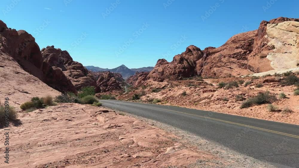 Winding road in the state park Valley of Fire in Nevada with red hills around Winding road in the state park Valley of Fire in Nevada with red hills around