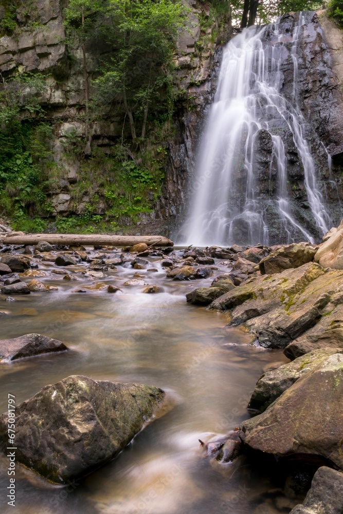Breathtaking view of a majestic waterfall cascading down from a rocky mountain peak Breathtaking view of a majestic waterfall cascading down from a rocky mountain peak