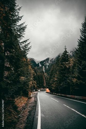 A vertical shot of a road in the Romanian mountains
