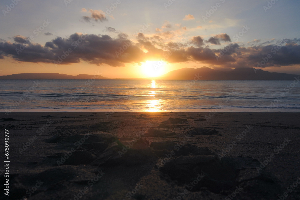 Beautiful golden sunrise, sands and blue sky on the beach.