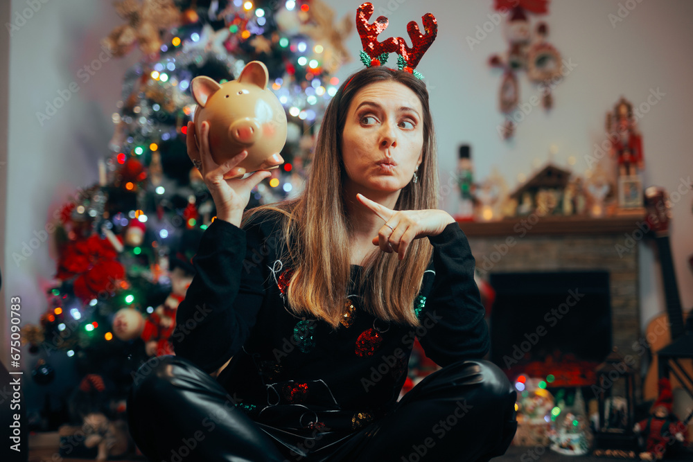 Funny Christmas Woman Pointing to a Piggy Bank. Cautious girl thinking not to overspend on holidays presents
Funny Christmas Woman Pointing to a Piggy Bank. Cautious girl thinking not to overspend on holidays presents