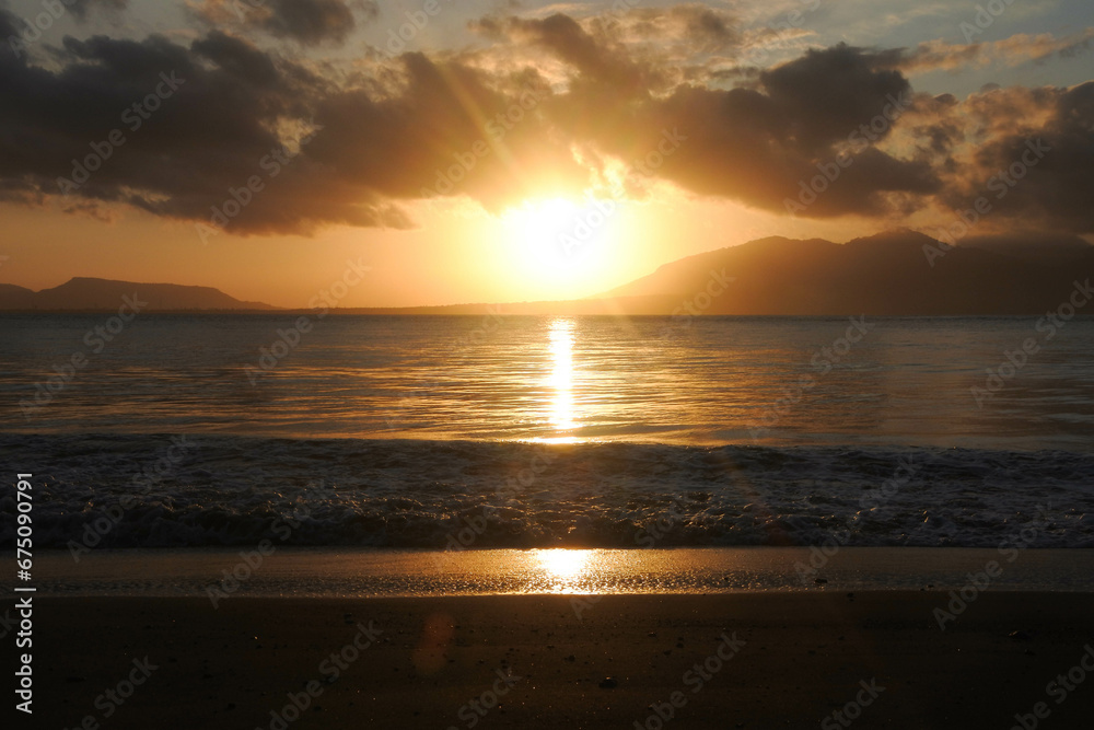 Beautiful golden sunrise, sands and blue sky on the beach.