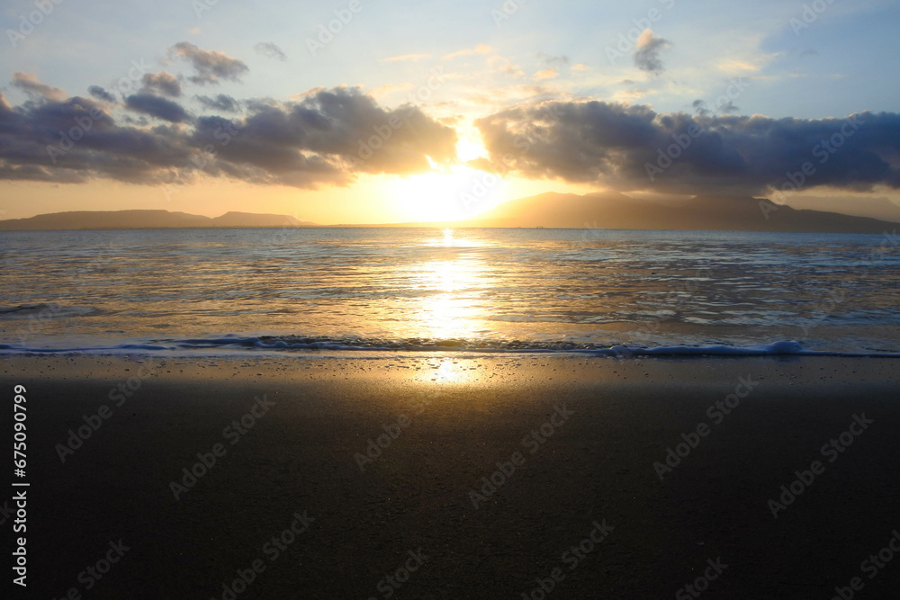 Beautiful golden sunrise, sands and blue sky on the beach.