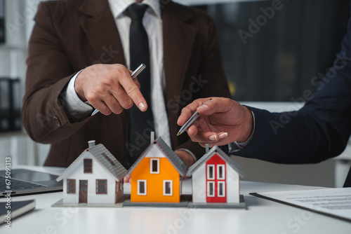 Real estate company to buy houses and land are delivering keys and houses to customers after agreeing to make a home purchase agreement and make a loan agreement. Discussion with a real estate agent