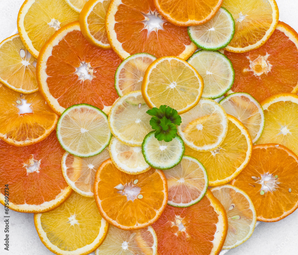 A group of sliced oranges and lemons decorated with green flower A group of sliced oranges and lemons decorated with green flower