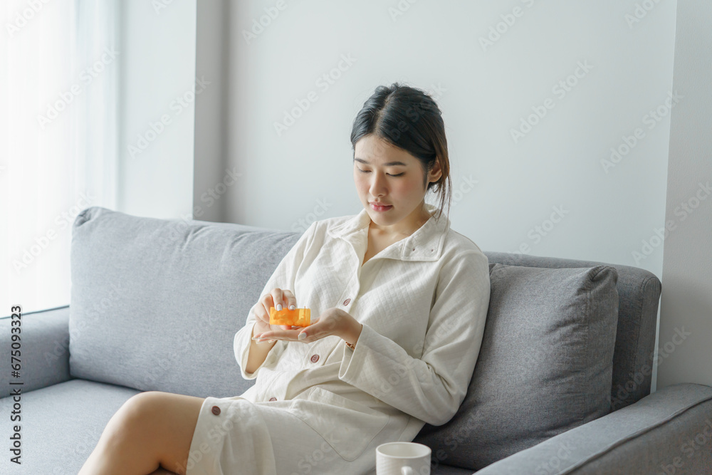 Asian woman taking medicine holding pill and water.self recover health care concept Asian woman taking medicine holding pill and water.self recover health care concept