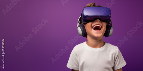 Young boy getting experience using VR headset glasses isolated on a purple background with copy space