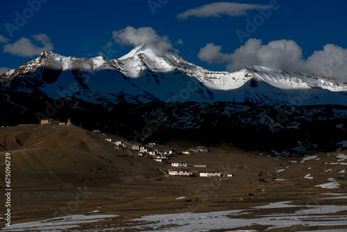 snow covered mountains in ancient village photo