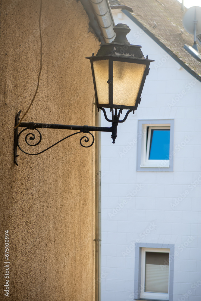Vintage smoke lamp on the exterior wall of homes in Rothenberg, Germany
