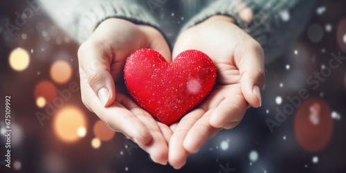 Hands holding gift box and heart cookies on a christmas background, giving love and generosity to loved ones.