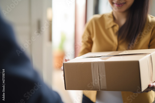 Woman Receiving and Unboxing Parcel at Home - Online Shopping Concept. photo