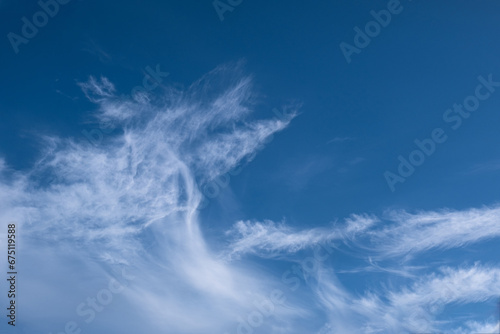 fluffy cirrus clouds in the blue sky. 