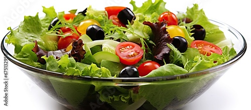 A young healthy salad made with fresh green leafy vegetables from a local farm bursts with vibrant colors against a white background showcasing the nutritious vitamins and natural beauty of 