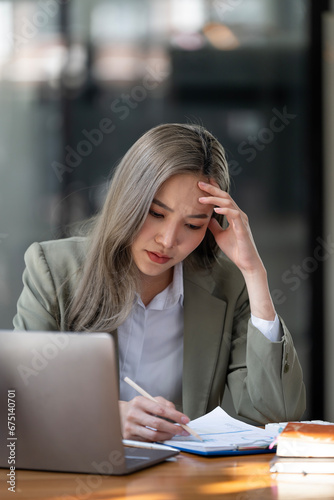 Young women are stressed while working on laptop, Tired businesswoman with headache at office, feeling sick at work, copy space