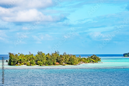 A small motu or islet on the coral reef just off the island of Bora Bora in French Polynesia.