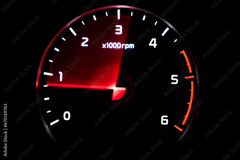 Close up shot of tachometer in car. Car dashboard. Dashboard details with indication lamps.Car instrument panel. Dashboard with tachometer isolated on black background