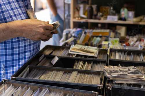 Unrecognizable man shopping at a flea market, selective focus on the hand