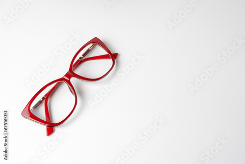 Women's glasses in red frames on a white background