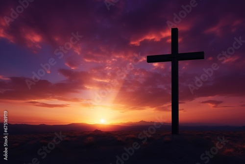 Silhouette of a cross on against a colorful sunset sky © Rudsaphon
