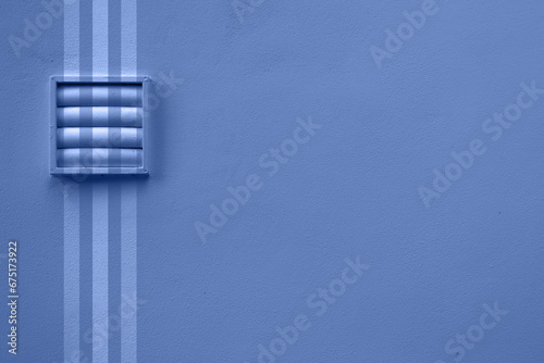 Outdoor fan on blue wall with three stripes photo