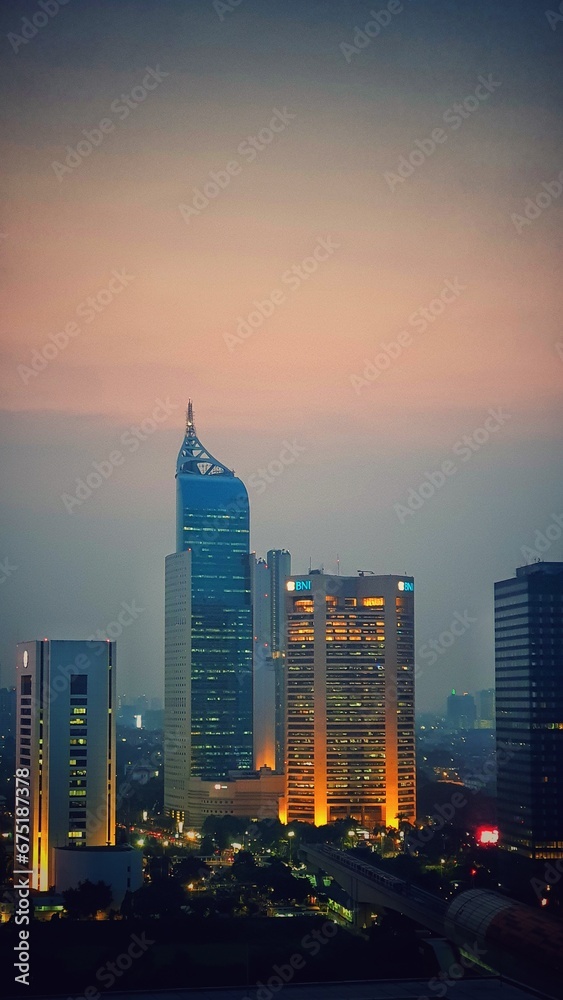 Fototapeta premium Jakarta, Indonesia – August 14, 2023: A sunset view cityscape of Indonesia capital city Jakarta