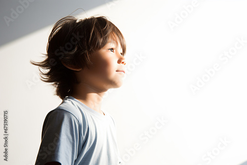 a young boy with a wii remote in his hand