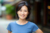 a woman in a blue shirt is smiling