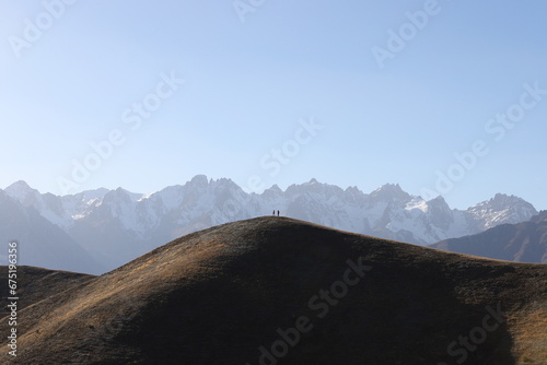 Group of mountaineers climbing a snowy mountain. Beautiful landscape background with silhouettes of climbers hiking on a peak.turkey