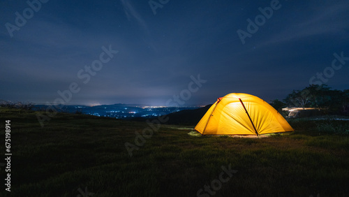 Camping tent at night on the mountain top. Vacation, travel, adventure concept