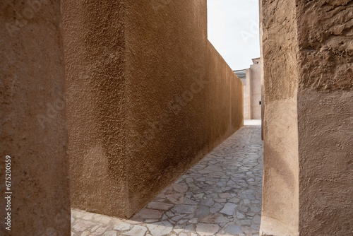 View of narrow clean streets between traditional stone buildings in old city Souk Madinat Jumeirah, Al Fahidi, Dubai, UAE, United Arab Emirates 