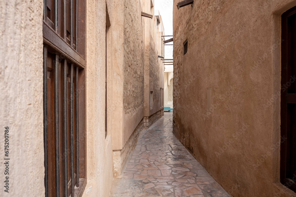View of narrow clean streets between traditional stone buildings in old city Souk Madinat Jumeirah, Al Fahidi, Dubai, UAE, United Arab Emirates 