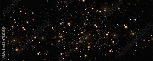 Golden sequins glow with many lights. Glittering dust. Luxurious background of golden particles.