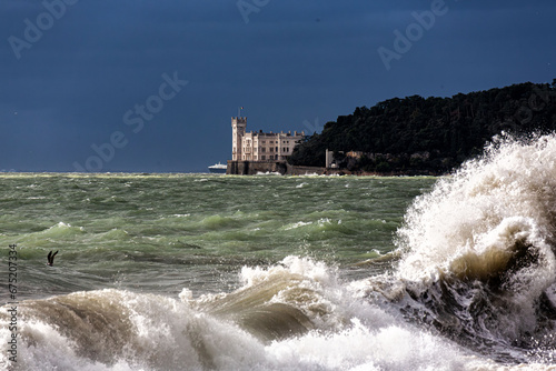 stormy sea with Miramare castle in the back