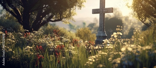 The cross stood tall in the landscape of the cemetery with an herb garden blooming beside it while the intricate detail of the crucifix adorned the tomb
