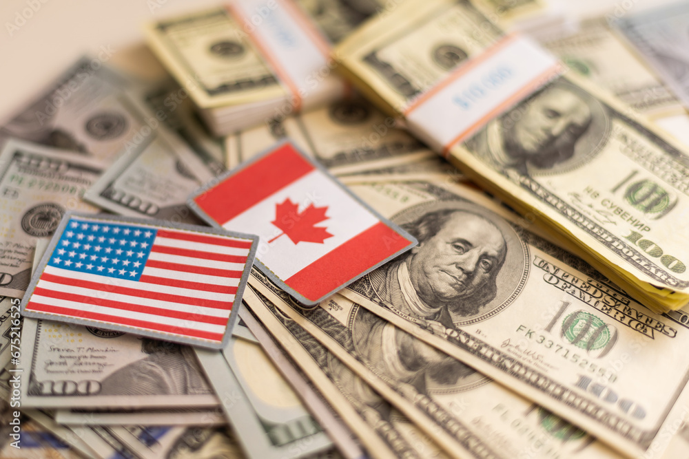 Flag of Canada sticking in a variety of american banknotes.(series) Flag of Canada sticking in a variety of american banknotes.(series)