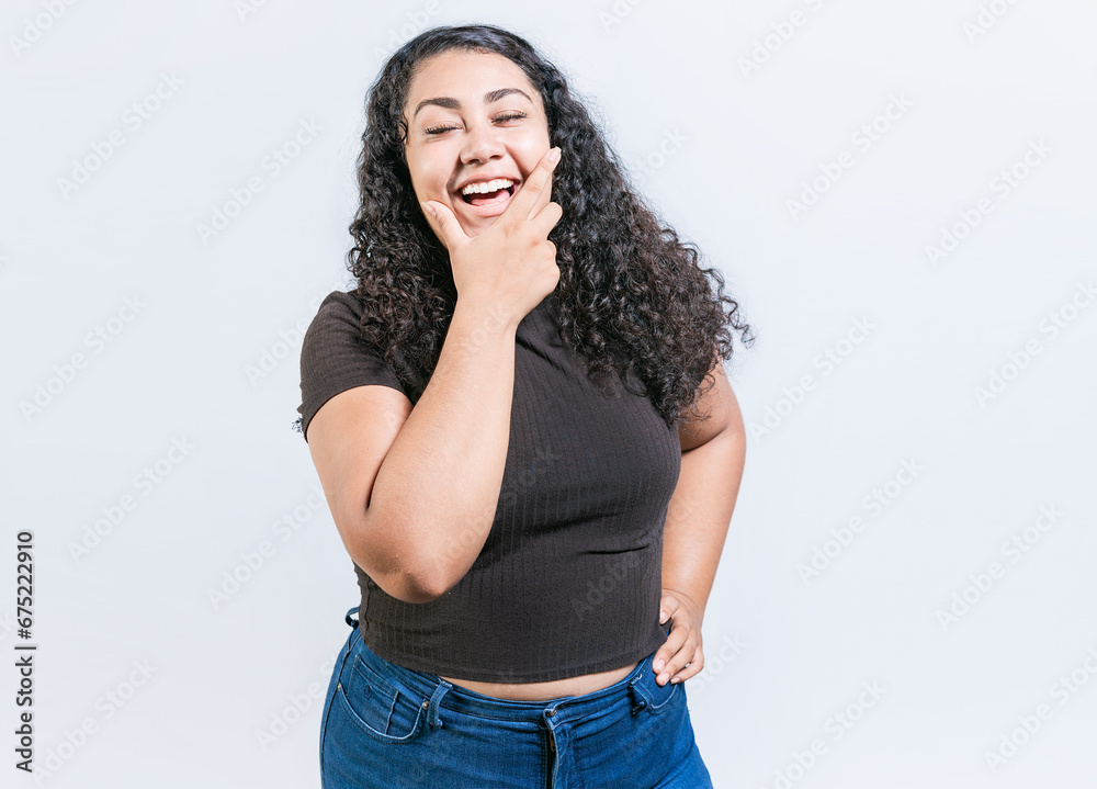 Happy young latin woman holding chin laughing isolated. Portrait of funny latin woman smiling isolated. Portrait of young woman nicaraguan Happy young latin woman holding chin laughing isolated. Portrait of funny latin woman smiling isolated. Portrait of young woman nicaraguan
