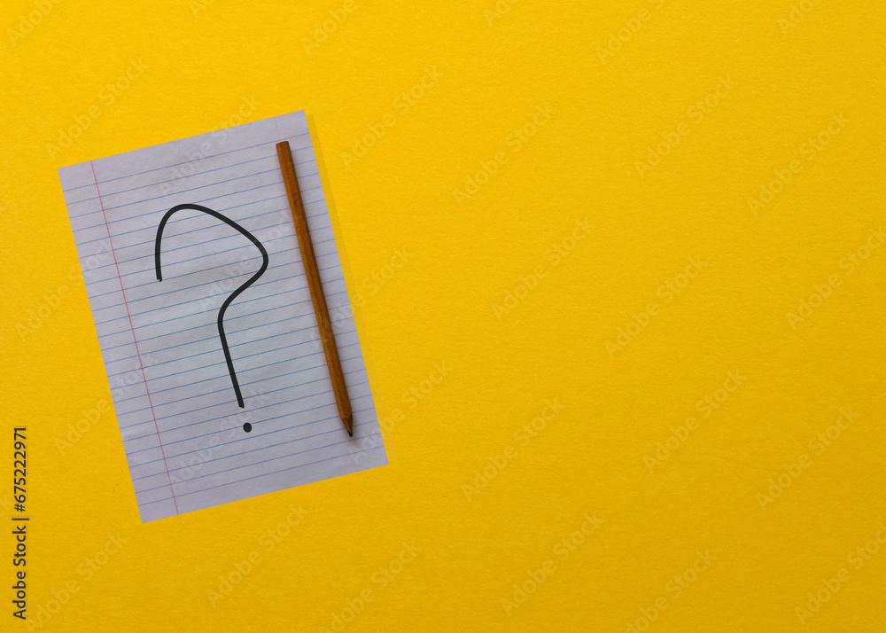 A4 paper on yellow background with a question mark on it. Question mark ...