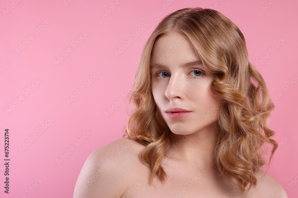 Portrait of beautiful woman with blonde hair on pink background. Space for text