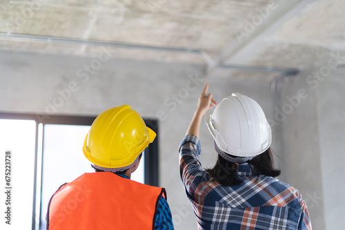 Картината върху платно Client and Contractor discussing plan to renovation house.